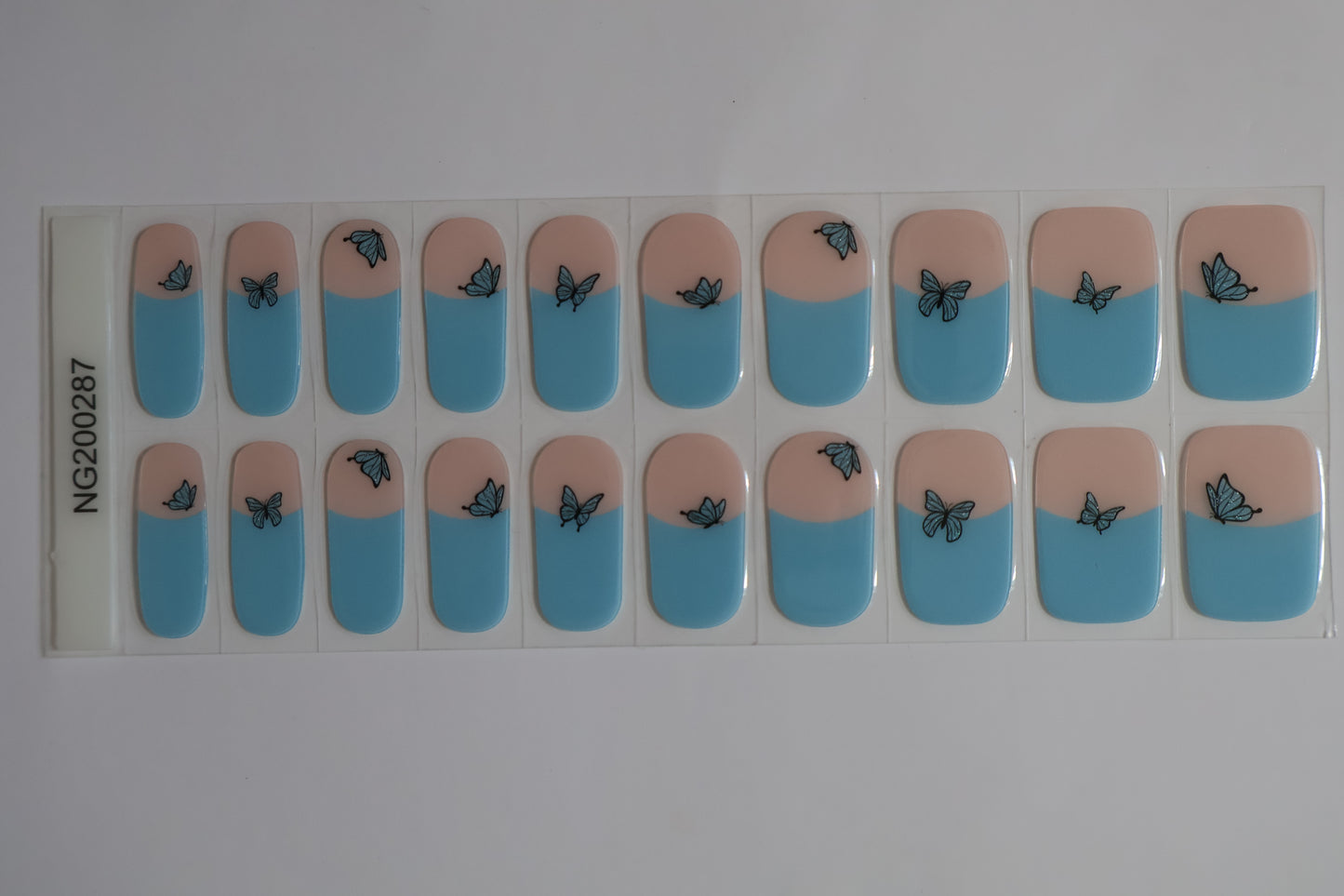 Close up of Butterfly gel nail stickers sheet with multiple sizes and soft colour tones