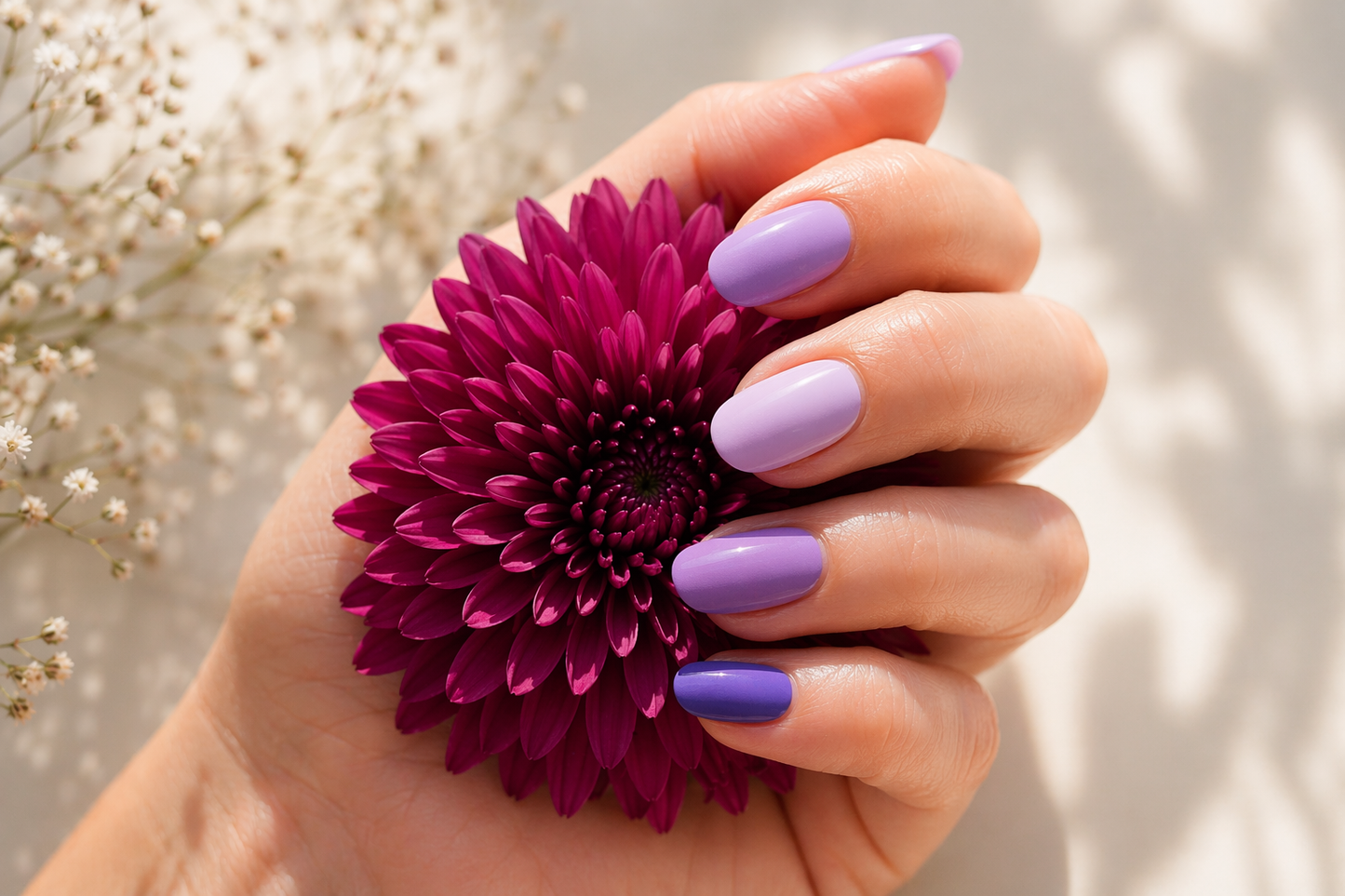 Finished semi cured gel nails on hand holding a flower, glossy salon-style manicure result